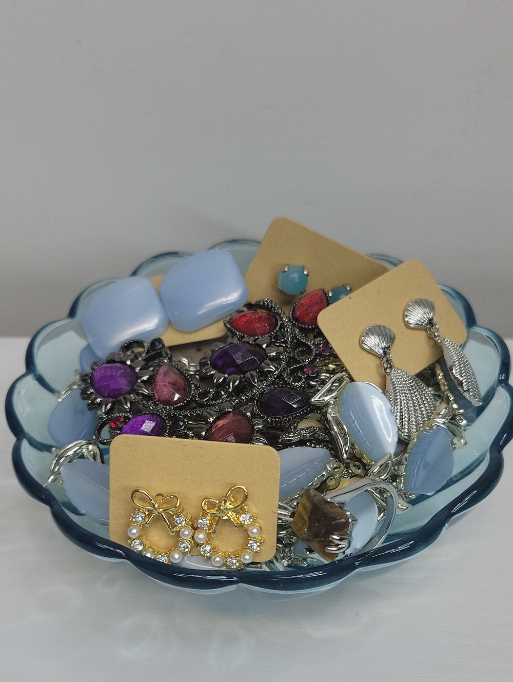 Blue Glass Dish Filled With Jewelry